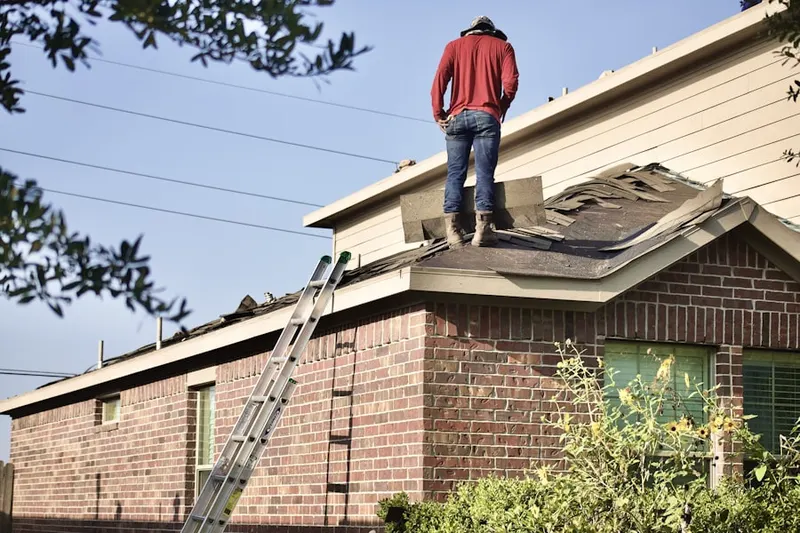 Professional roofer working on a residential roof in Caribou